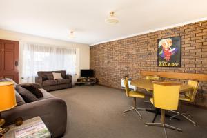 a living room with a couch and a table at Mildura Holiday Apartments in Mildura