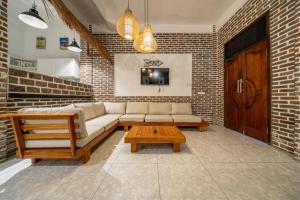 a living room with a couch and a coffee table at Luxury 3-Bedroom Pool Villa in Canggu Near Beach & Nightlife in Canggu