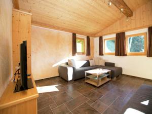 a living room with a couch and a tv at Chalet in Hopfgarten in Hopfgarten im Brixental +46 photos