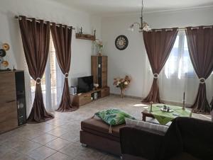 a living room with a couch and a table at PENELOPE'S apartment in Kefalonia