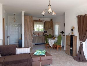 a living room and kitchen with a couch and a table at PENELOPE'S apartment in Kefalonia
