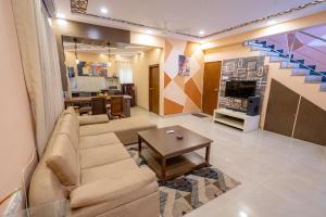 a living room with a couch and a table at Lostparadise 3bedroom villa in Vagator