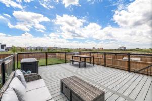 a deck with a table and a bench on a deck at Magnificent Stylish Escape in Bélanger