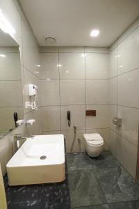 a bathroom with a sink and a toilet at Hotel Abaam Neil in Kumarakom +8 photos
