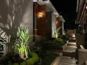 a house with a garden at night at The Banjar Homestay in Sidemen
