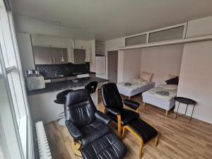a living room with a couch and chairs and a bed at JR Apartaments in Esbjerg