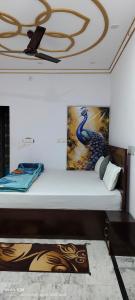 a bed in a room with a painting on the ceiling at Shri Dev Dham in Vrindāvan