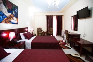 Postel nebo postele na pokoji v ubytování Orchidea Hotel