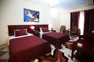 Postel nebo postele na pokoji v ubytování Orchidea Hotel