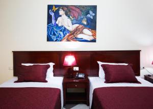 Postel nebo postele na pokoji v ubytování Orchidea Hotel