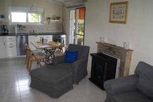 a living room with a table and chairs and a stove at O Ioannis in Kritinía