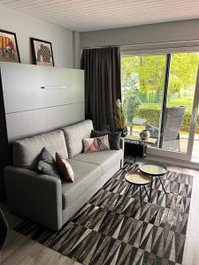 Una sala de estar con un sofá y una ventana grande. en Bellevue Nr. 14, en Scharbeutz