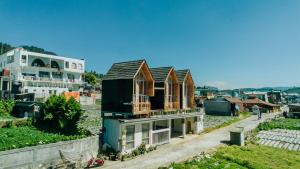 a group of houses with windows on top of them at Kijang Mas By Travelink in Dieng