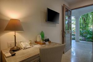 a room with a desk with a phone and a lamp at OK Divers Resort & Spa in Padangbai