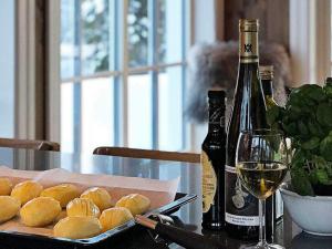 a table with a plate of food and a bottle of wine at 12 person holiday home in Fåvang in Favang +21 photos