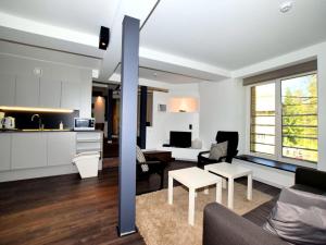 a living room and kitchen with a couch and a table at Manor house flat in Robertville in Robertville