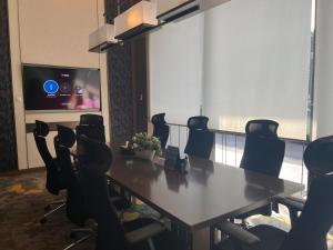 a conference room with a table and chairs at Steph's APT 31 Sudirman Suites Makassar in Makassar +4 photos