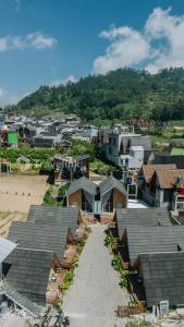 an aerial view of a town with houses at Quenz Cabin By Travelink in Dieng +3 photos