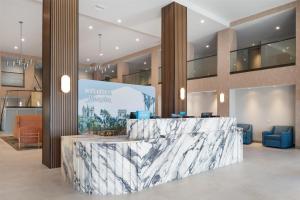 a lobby with a marble counter in a building at Hampton Inn & Suites San Diego Seaworld in San Diego +19 photos
