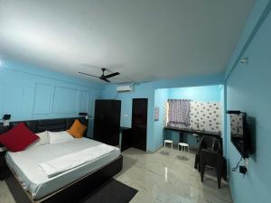 a bedroom with a bed and a tv in it at The Boss House in Arambol