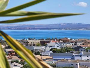 a city with houses and the ocean in the background at Alabaster Luxe Villa in Langebaan