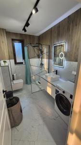 a bathroom with a sink and a shower and a toilet at Matei Rent Apartments - Premium Stays & Free Parking in Baia Mare