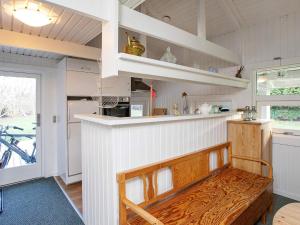a kitchen with a wooden bench in a room at 4 person holiday home in Præstø in Præstø +32 photos