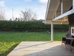a porch of a house with a table and chairs at 4 person holiday home in Præstø in Præstø