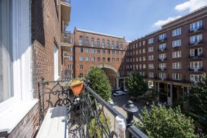 a balcony with a bike parked on the ledge of a building at Central 4BEDROOM Madách Square Apartment in Budapest
