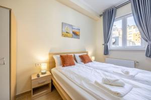 a bedroom with a large bed with a window at Central 4BEDROOM Madách Square Apartment in Budapest