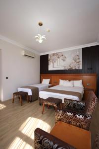 a hotel room with two beds and a couch at New House Hotel in Istanbul +83 photos