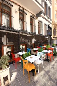 a patio with tables and chairs in front of a building at New House Hotel in Istanbul