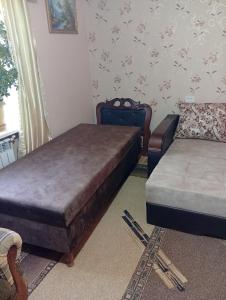 a bedroom with two beds and a couch at Anush in Sisian