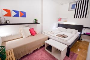 a living room with a couch and a table at Adela Apartments in Dramalj