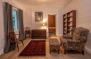 a living room with two chairs and a table at Cozy Cottage Blue Mountains in Lowther