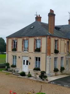 a large brick house with a white door at Logis Hotels Restaurants- Villa des Bordes in Cléry-Saint-André +33 photos