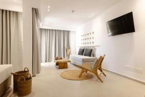 a living room with a chair and a couch at Andreotis Hotel Apts in Protaras