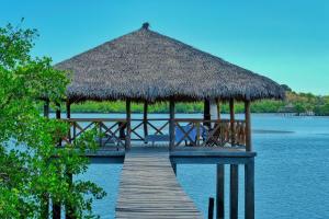 a pier with a hut on the water at Villa SAHONDRA in Nosy Be