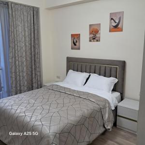 a bedroom with a bed with a gray comforter at New Alvina 44 in Tsaghkadzor +20 photos