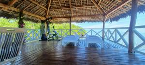 a porch of a resort with a view of the ocean at Villa SAHONDRA in Nosy Be