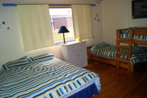 a bedroom with two beds and a window at Inlet Side Eden in Inverloch