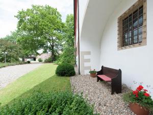 a bench sitting next to a building with a window at Studio in Saxony near Dübener Heide in Arzberg