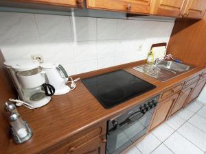 a kitchen counter with two coffee makers and a sink at Studio in Saxony near Dübener Heide in Arzberg