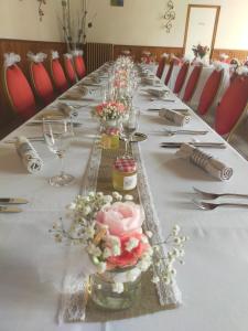 a long table with glasses and flowers on it at Logis Hotels Restaurants- Villa des Bordes in Cléry-Saint-André