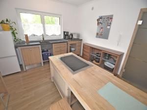 a kitchen with a wooden counter top in a room at Bodenwöhr Lakeside Gem in Bodenwöhr