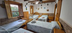 a room with several tables and chairs in a room at Casa Renacimiento in Coín