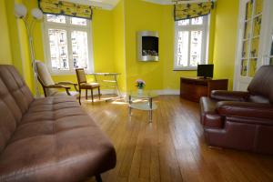 a living room with a couch and a table at Gites de l'Austrasie in Metz