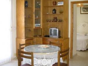 a dining room with a table and a tv at Apartamento Maria Angeles in Tarifa