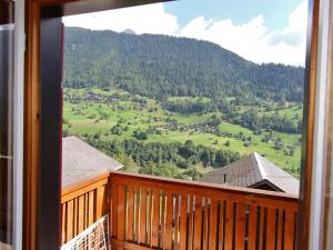 a balcony with a view of a green field at Chalet in Wiler near Ski Lift & Views in Fiesch