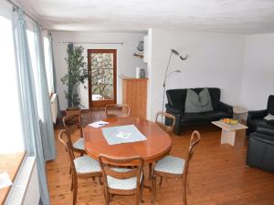 a living room with a wooden table and chairs at Ferienhaus in Herrischried in Herrischried
